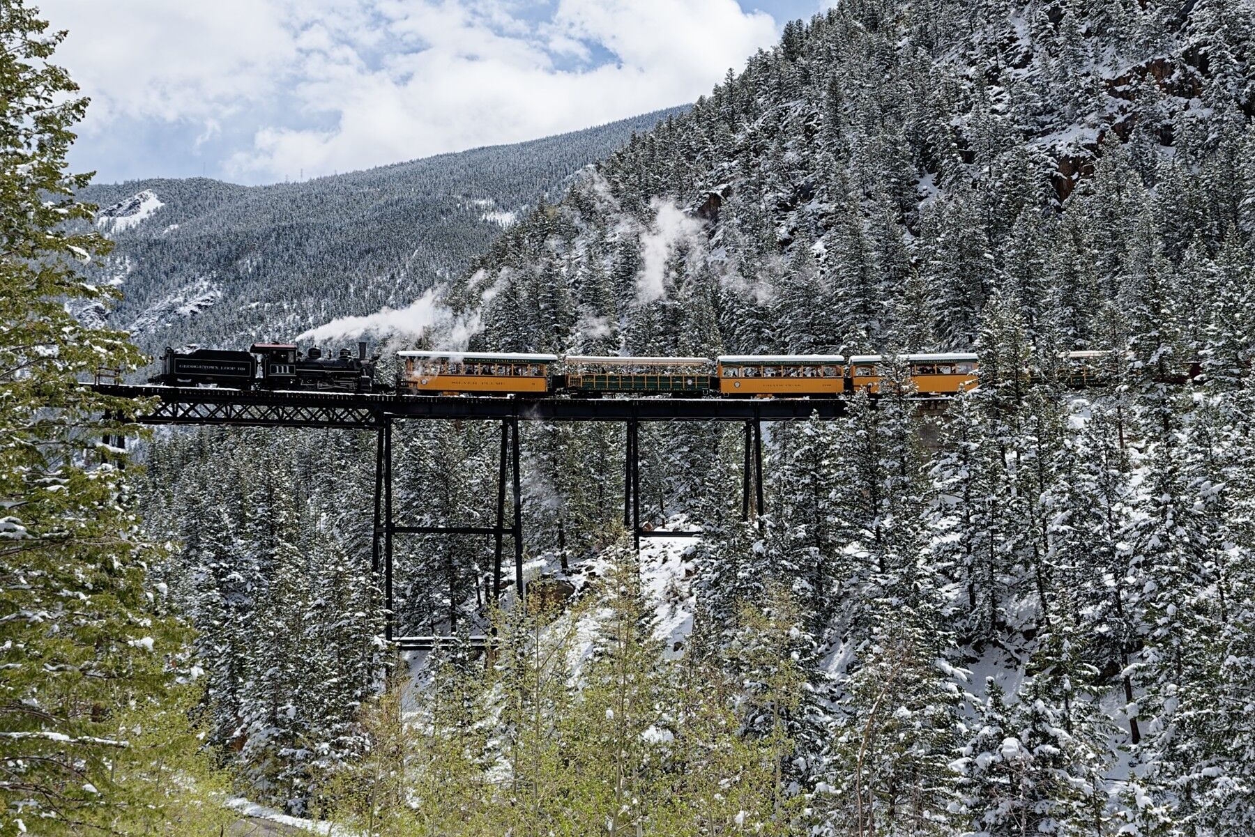 Over a foot of snow overnight with steam locomotive 111 crossing Devils Gate in a winter scene in May. Devils Gate High Bridge...