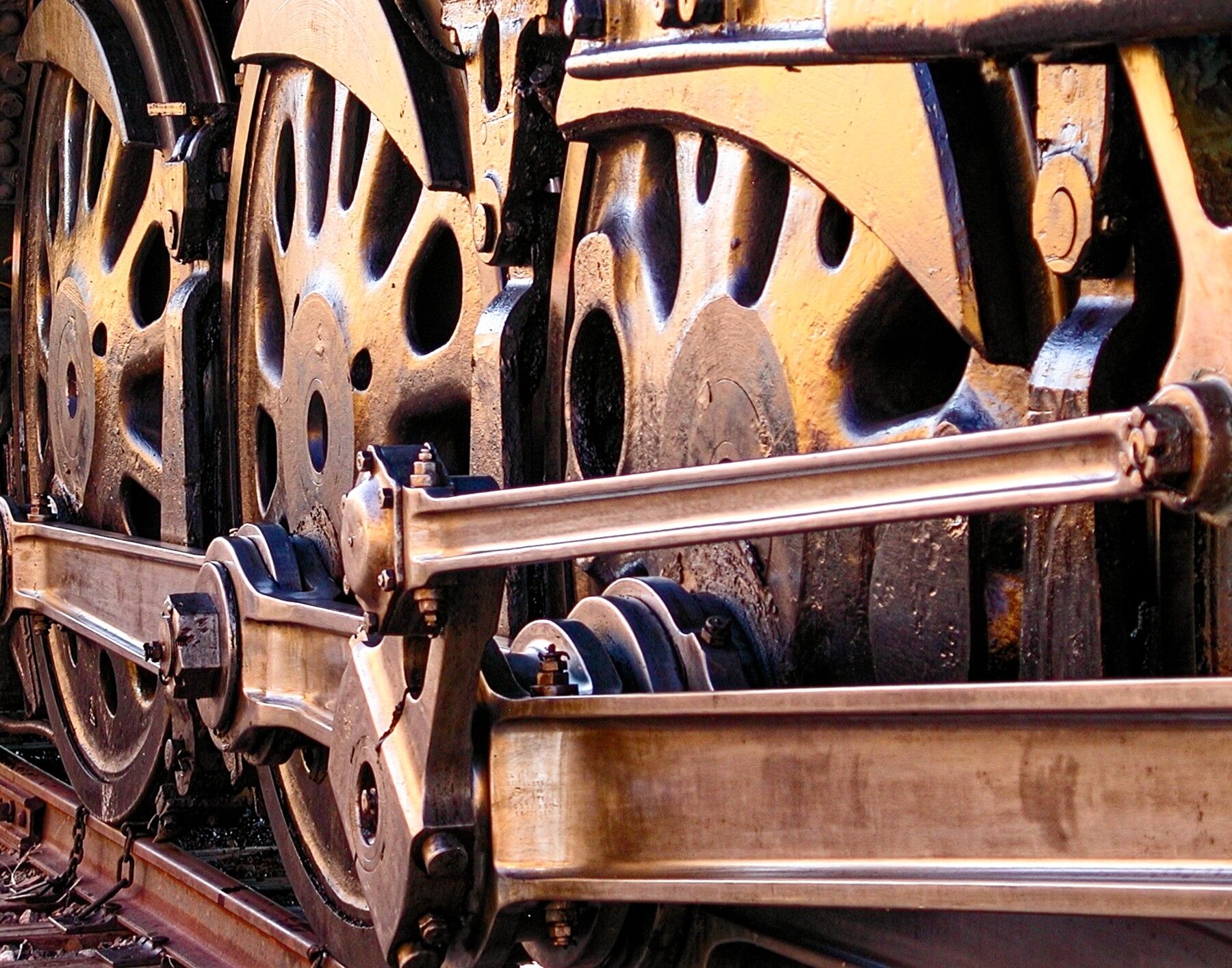 The huge set of wheels are on Union Pacific steam locomotive 844. The reflecting colors are coming from the UP passenger cars...