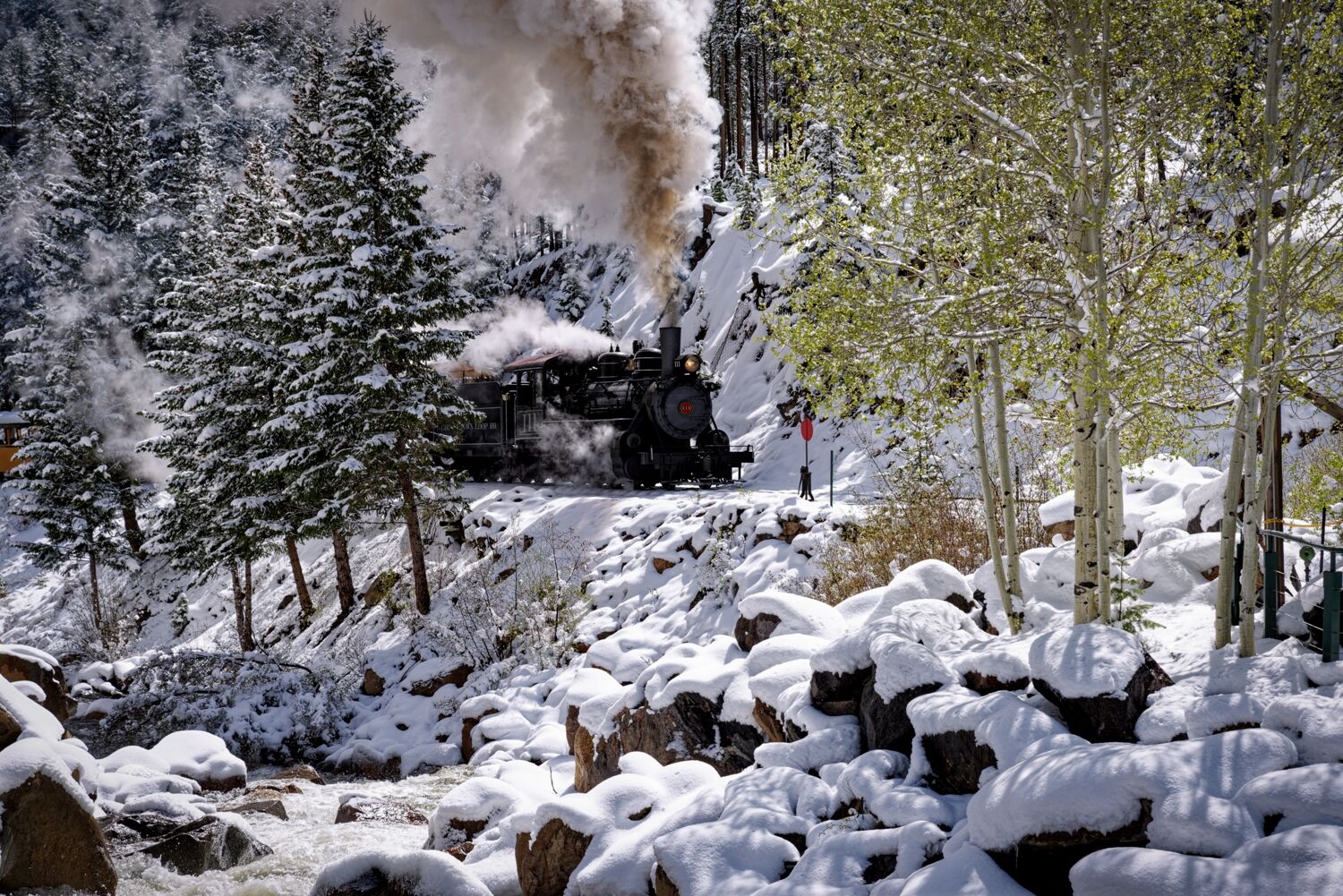 Running around the passenger train at the switch at Devils Gate station in Georgetown Colorado. Fresh snow blankets the ground...