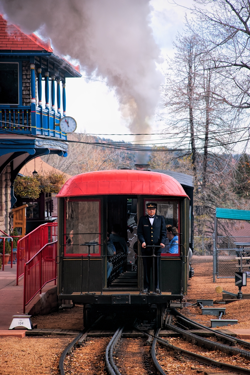 The conductor is still greeting passengers until the 12pm departure time from the station in Manitou Springs Colorado. At twelve...