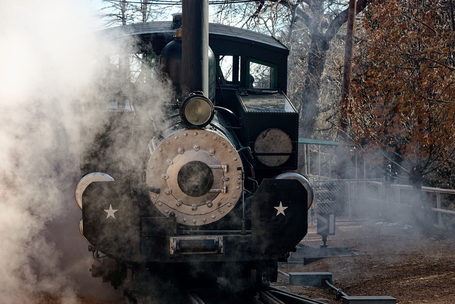 Steam locomotive number 4 moving forward like a bullet in the Manitou Pikes Peak Cog Railway yard in Manitou Springs Colorado...